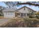 Charming single story home with a screened porch and well-manicured lawn at 1321 Riverside Dr, Tarpon Springs, FL 34689