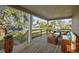 Relaxing front porch with wicker furniture and wood flooring at 1321 Riverside Dr, Tarpon Springs, FL 34689
