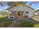 Back of house showing a deck and landscaping at 1321 Riverside Dr, Tarpon Springs, FL 34689