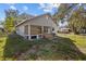 Backyard view of a single-story house with a deck at 1321 Riverside Dr, Tarpon Springs, FL 34689