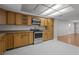 Well-equipped kitchen featuring wood cabinets and tile flooring at 1321 Riverside Dr, Tarpon Springs, FL 34689