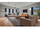 Open living room with hardwood floors, comfortable seating, and large windows at 1321 Riverside Dr, Tarpon Springs, FL 34689