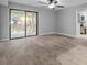 Bright living room featuring tile floors and sliding glass doors leading to a patio at 1321 Riverside Dr, Tarpon Springs, FL 34689
