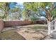 Large backyard with a wooden fence, providing a private and secluded outdoor area at 1503 E Cayuga St, Tampa, FL 33610