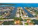 Gorgeous aerial view showcases canal-front properties with boats, swimming pools, mature vegetation, and beautiful coastal living at 1997 Kansas Ne Ave, St Petersburg, FL 33703
