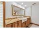 Bathroom showcasing marble counters, a basin sink, framed mirror, and white walls at 1997 Kansas Ne Ave, St Petersburg, FL 33703
