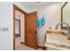 Bathroom showcasing a wood door, marble countertop, white basin sink, faucet and turquoise towels at 1997 Kansas Ne Ave, St Petersburg, FL 33703
