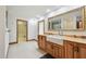Large bathroom showcasing a basin sink, marble counters, framed mirror, and doorway to walk-in closet at 1997 Kansas Ne Ave, St Petersburg, FL 33703