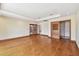 Open bedroom with hardwood floors, tray ceiling, sliding glass doors to lanai, and closet with wooden doors at 1997 Kansas Ne Ave, St Petersburg, FL 33703