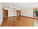 Spacious bedroom with hardwood floors, tray ceiling, window, and closet with wooden door at 1997 Kansas Ne Ave, St Petersburg, FL 33703