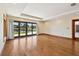 Bright bedroom with hardwood floors, tray ceiling, and sliding glass doors to lanai with waterfront views at 1997 Kansas Ne Ave, St Petersburg, FL 33703
