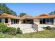 Exterior view of home with a travertine patio, tile roof, and manicured lawn at 1997 Kansas Ne Ave, St Petersburg, FL 33703