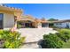 Exterior of home showcasing the travertine patio, tile roof, and verdant landscaping at 1997 Kansas Ne Ave, St Petersburg, FL 33703