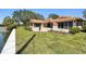 Exterior of home with travertine patio, waterfront access, and well-maintained lawn at 1997 Kansas Ne Ave, St Petersburg, FL 33703