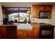 Kitchen with farmhouse sink, wood cabinets, and stainless steel appliances at 1997 Kansas Ne Ave, St Petersburg, FL 33703