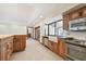 Modern kitchen design with stainless appliances, wooden cabinets, and tile floors at 1997 Kansas Ne Ave, St Petersburg, FL 33703