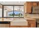 Modern kitchen with stainless appliances, wooden cabinets, large window and undermount sink at 1997 Kansas Ne Ave, St Petersburg, FL 33703