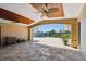 Outdoor lanai with travertine flooring, wood-paneled ceiling, ceiling fans, and waterfront views at 1997 Kansas Ne Ave, St Petersburg, FL 33703