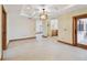 Living room with neutral walls, tiled floors, decorative light fixture, and views of patio at 1997 Kansas Ne Ave, St Petersburg, FL 33703