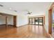 Bright living room featuring wood floors, neutral walls, wood trim, recessed lights, and a sliding glass door at 1997 Kansas Ne Ave, St Petersburg, FL 33703