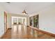 Open-concept living space with hardwood floors, natural light, and neutral paint at 1997 Kansas Ne Ave, St Petersburg, FL 33703