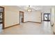 Living room with neutral walls, tile flooring, views to laundry room, and heron decor at 1997 Kansas Ne Ave, St Petersburg, FL 33703