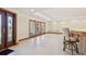Large living area featuring white tile flooring, many windows and a wet bar at 1997 Kansas Ne Ave, St Petersburg, FL 33703