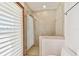 An updated shower with neutral tiling, glass doors, and a large adjustable shower head at 1997 Kansas Ne Ave, St Petersburg, FL 33703