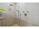 Walk-in shower featuring gray tiling, shower heads, and a safety bar at 1997 Kansas Ne Ave, St Petersburg, FL 33703