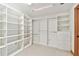 Spacious walk-in closet featuring custom shelving, drawers, and hanging rods for organized storage at 1997 Kansas Ne Ave, St Petersburg, FL 33703