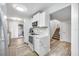 Modern white kitchen with quartz countertops and stainless steel appliances at 2062 Sunset Point Rd # 65, Clearwater, FL 33765