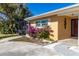Side view of the house with vibrant flowers at 209 Westwinds Dr, Palm Harbor, FL 34683