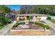 Attractive single-story home with landscaped yard and circular driveway at 209 Westwinds Dr, Palm Harbor, FL 34683