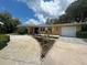 Well-maintained home with lush front yard landscaping, an inviting entrance and attached garage, offering both beauty and functionality at 209 Westwinds Dr, Palm Harbor, FL 34683