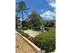 Manicured front yard with lush landscaping, offering curb appeal and complementing the charm of this inviting home at 209 Westwinds Dr, Palm Harbor, FL 34683