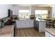 Modern kitchen with white cabinets, granite countertops and stainless steel appliances at 209 Westwinds Dr, Palm Harbor, FL 34683