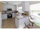 Updated kitchen boasting white cabinetry, granite counters, and stainless steel appliances at 209 Westwinds Dr, Palm Harbor, FL 34683