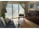Comfortable living room with a light hardwood floors and sliding glass doors at 209 Westwinds Dr, Palm Harbor, FL 34683