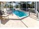 Inviting screened pool area with lounge chair at 209 Westwinds Dr, Palm Harbor, FL 34683