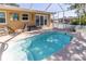 Refreshing screened pool with patio furniture at 209 Westwinds Dr, Palm Harbor, FL 34683