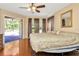 Main bedroom with hardwood floors and pool access at 2107 Gallagher Rd, Dover, FL 33527