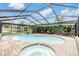 Inviting pool and spa with screened enclosure and brick pavers at 3018 Prestige Dr, Clearwater, FL 33759