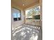 Covered balcony with decorative balustrade, overlooking trees and landscaping at 3050 Wentworth Way, Tarpon Springs, FL 34688