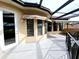 Spacious tiled balcony with outdoor furniture and awning at 3050 Wentworth Way, Tarpon Springs, FL 34688