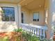 Balcony with white balustrade, surrounded by landscaping at 3050 Wentworth Way, Tarpon Springs, FL 34688