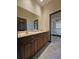 Dual vanity bathroom with wooden cabinetry and tile flooring at 3050 Wentworth Way, Tarpon Springs, FL 34688