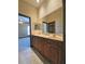 Spacious bathroom with double vanity, wood cabinetry, and tile floor at 3050 Wentworth Way, Tarpon Springs, FL 34688