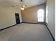 Empty bedroom with carpet, ceiling fan, and arched window at 3050 Wentworth Way, Tarpon Springs, FL 34688