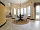 Breakfast nook with a round table and chairs, tile flooring, and large windows at 3050 Wentworth Way, Tarpon Springs, FL 34688