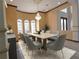 Bright dining room with large windows, chandelier, and spacious table with seating for eight at 3050 Wentworth Way, Tarpon Springs, FL 34688